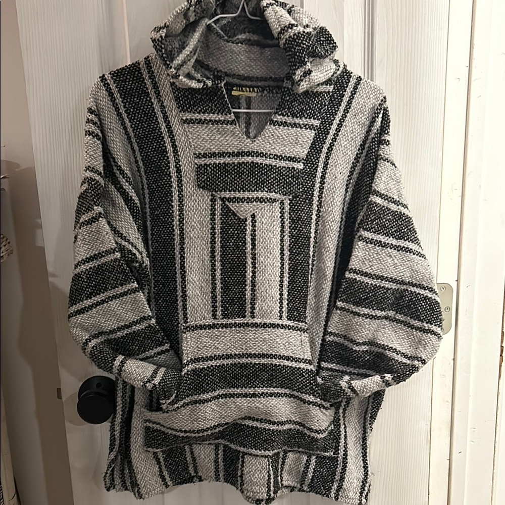 Black and grey (or really dark grey and light grey) Pancho/drug rug. Small